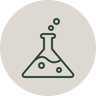 Laboratory flask with bubbles inside, beige background.
